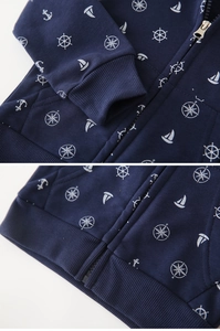 Detail of nautical print on navy kids hoodie showing anchor patterns and ribbed cuffs