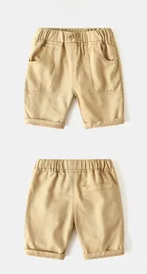 Detail view of khaki cotton twill boys shorts featuring elastic waist and side pockets