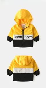 Detail of kids hooded windbreaker featuring color-block design and GOOD BOYS text print
