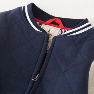 Navy blue quilted boy's jacket with striped rib collar and zip closure detail