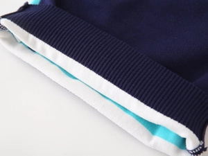 Detail of ribbed knit cuffs featuring navy blue, white, and bright cyan striped patterns