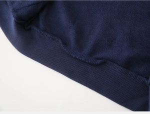 Detailed macro view of dark blue ribbed cuffs and soft fleece lining of kids hoodie