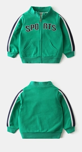 Detail showing green boys' sports jacket with contrast side stripes and letter embroidery