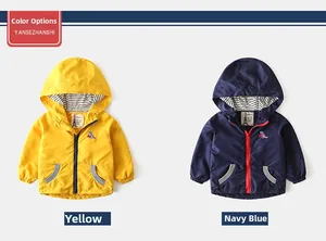 Detail of kids hooded jackets with dinosaur embroidery and striped lining textures
