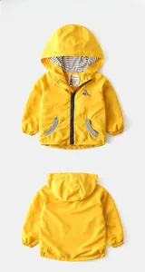Detail of yellow toddler dinosaur hoodie showing embroidered patch and zip-up front closure
