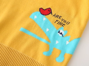 Detail of yellow knit sweater featuring cartoon dinosaur and Are You Fine text embroidery