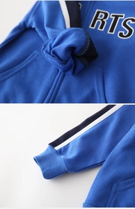 Detail of blue hoodie fabric texture with RTS letter print and sporty striped tape sleeves