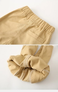 Detail of khaki cotton shorts showing elastic waistband and interior stitching quality