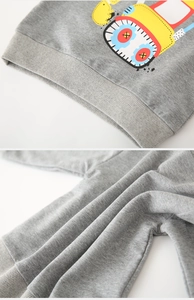 Close-up of gray kids sweatshirt showing rib-knit hem and cartoon excavator print