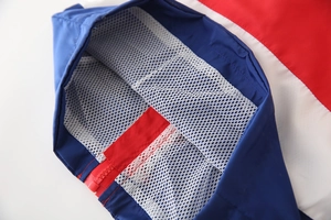 Detail of kids hooded windbreaker featuring breathable mesh lining and zipper