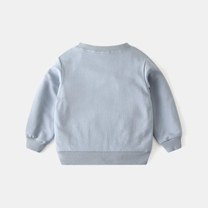 Detail view of the ribbed cuffs and back of a light blue cotton sweatshirt for kids