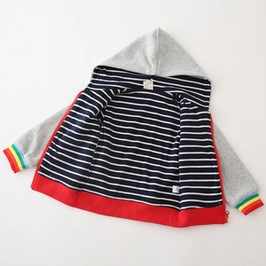 Flat lay of color-block boys' hooded zip jacket with striped lining and rainbow cuffs