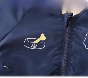 Detail of kids jacket fabric showing a bone print and smooth nylon zipper closure