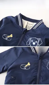Detail of kids baseball jacket featuring striped knit collar and cute cartoon dog print
