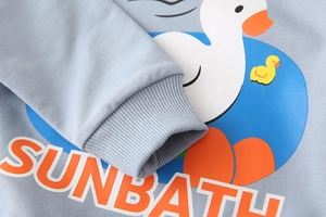 Detail of ribbed cuffs and high-quality cotton fabric on blue cartoon duck sweatshirt