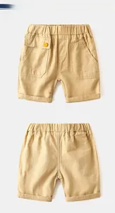 Detailed flat lay of khaki boys cargo shorts showing elastic waist and utility pockets