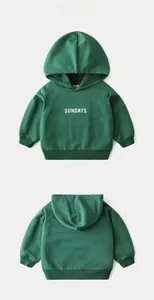 Detail view of dark green kids hoodie with SUNDAYS print, ribbed cuffs and hood