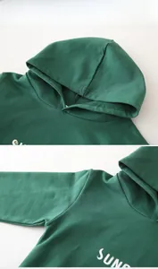 Detailed view of dark green kids hoodie showing hood and stitching quality