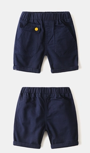 Detail of dark blue boys leisure shorts with elastic waist and yellow button accent