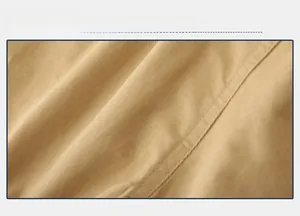 Close-up of khaki twill cotton fabric showing fine texture and double stitching detail