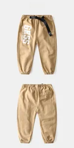 Flat lay of khaki kids cargo pants with black belt and white letter printing