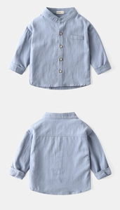 Detail view of boys' light blue stand-collar cotton linen shirt with wood texture buttons