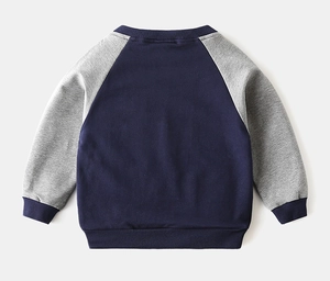 Detail of kids crewneck sweatshirt featuring navy body and grey raglan sleeves