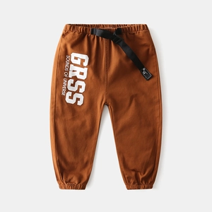 Detail of kids caramel joggers featuring elastic waistband and white letter print