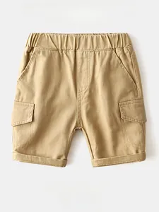 Detail of khaki cargo shorts for boys featuring elastic waistband and functional side pockets