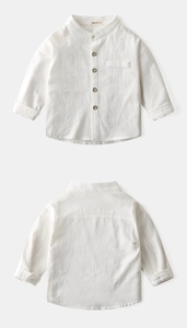 Detail view of white cotton linen boy's shirt with mandarin collar and wooden buttons