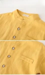 Detail of yellow cotton kid shirt showing mandarin collar and wooden button texture