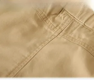 Macro view of khaki cotton twill fabric with precision double-stitch sewing details