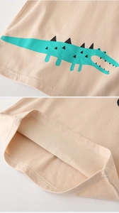 Detail of cartoon crocodile print and double-needle stitching on cotton kids t-shirt