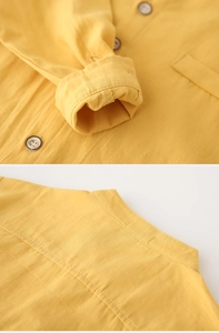 Detailed close-up of ginger cotton linen shirt with vintage buttons and stand collar texture