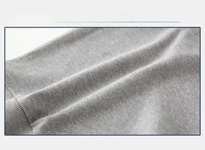 Close-up detail of soft light gray knitted fabric texture for kids sweatshirt top