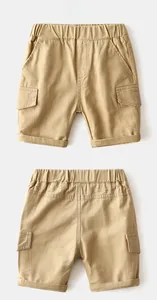 Detail of khaki cotton twill cargo shorts for boys with elastic waist and large flap pockets