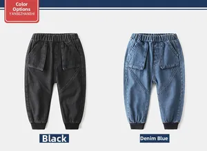 Detail view of children's joggers in black and denim blue with ribbed elastic cuffs