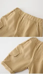 Detail of khaki cotton cargo shorts featuring elastic waistband and side pocket