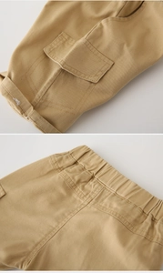 Detail of khaki cotton cargo shorts showing elastic waistband and stitching on pockets