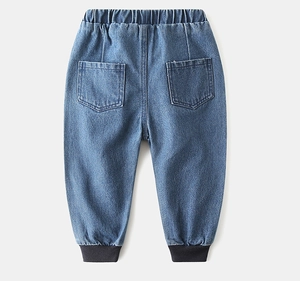 Detail of kids denim jeans featuring ribbed cuffs, elastic waist, and two back pockets