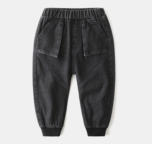 Detail of kids grey denim joggers featuring elastic waist and large front pockets