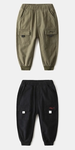 Detail of kids cargo pants with Hey embroidery on flap pockets and ribbed cuffs