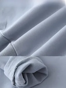 Macro view of light blue knitted terry fabric and ribbed cuff detail for children hoodie