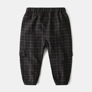 Detail of children's plaid joggers featuring elastic waist and red check pattern texture