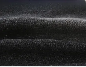 Macro view of dark gray twill denim fabric texture with fine fiber details and thickness