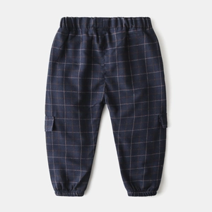 Detail of dark blue plaid pants with elastic waistband and cargo pockets for boys