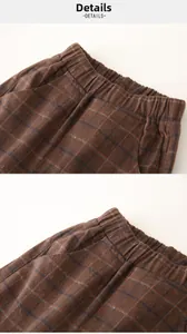Detail of children's plaid pants showing elastic waistband and soft cotton texture
