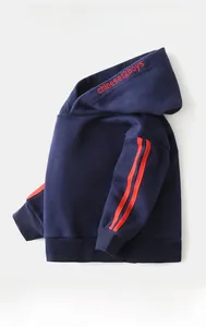 Detail of navy blue hoodie with red sleeve stripes and soft fleece lining for kids