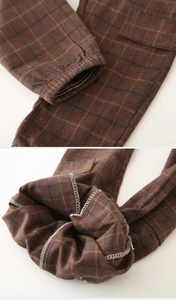 Detail of brown plaid pants showing quality inner stitching and elastic ankle cuffs