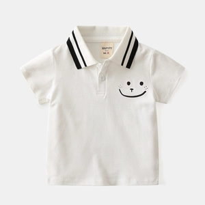 Close-up of white kids polo shirt featuring striped collar and cartoon smiley face